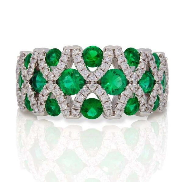 Elegant emerald and diamond statement ring with intricate design.