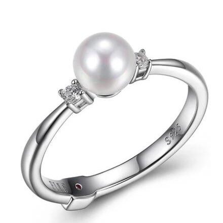 Elegant silver ring with a single pearl centerpiece.