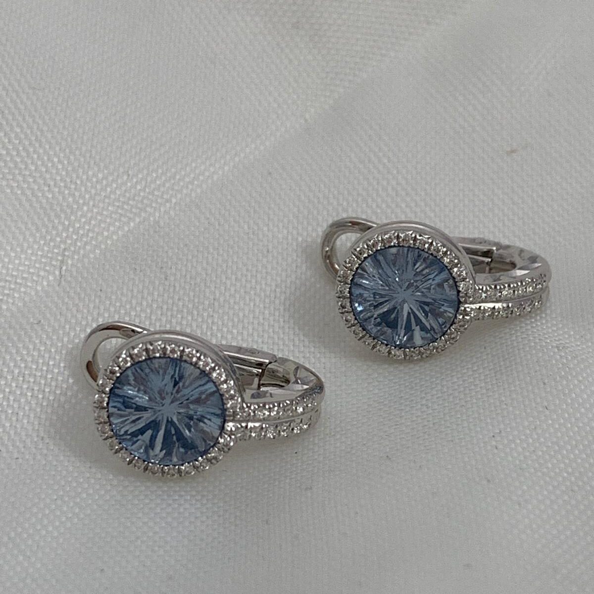 Elegant silver rings with blue gemstones on a light surface.