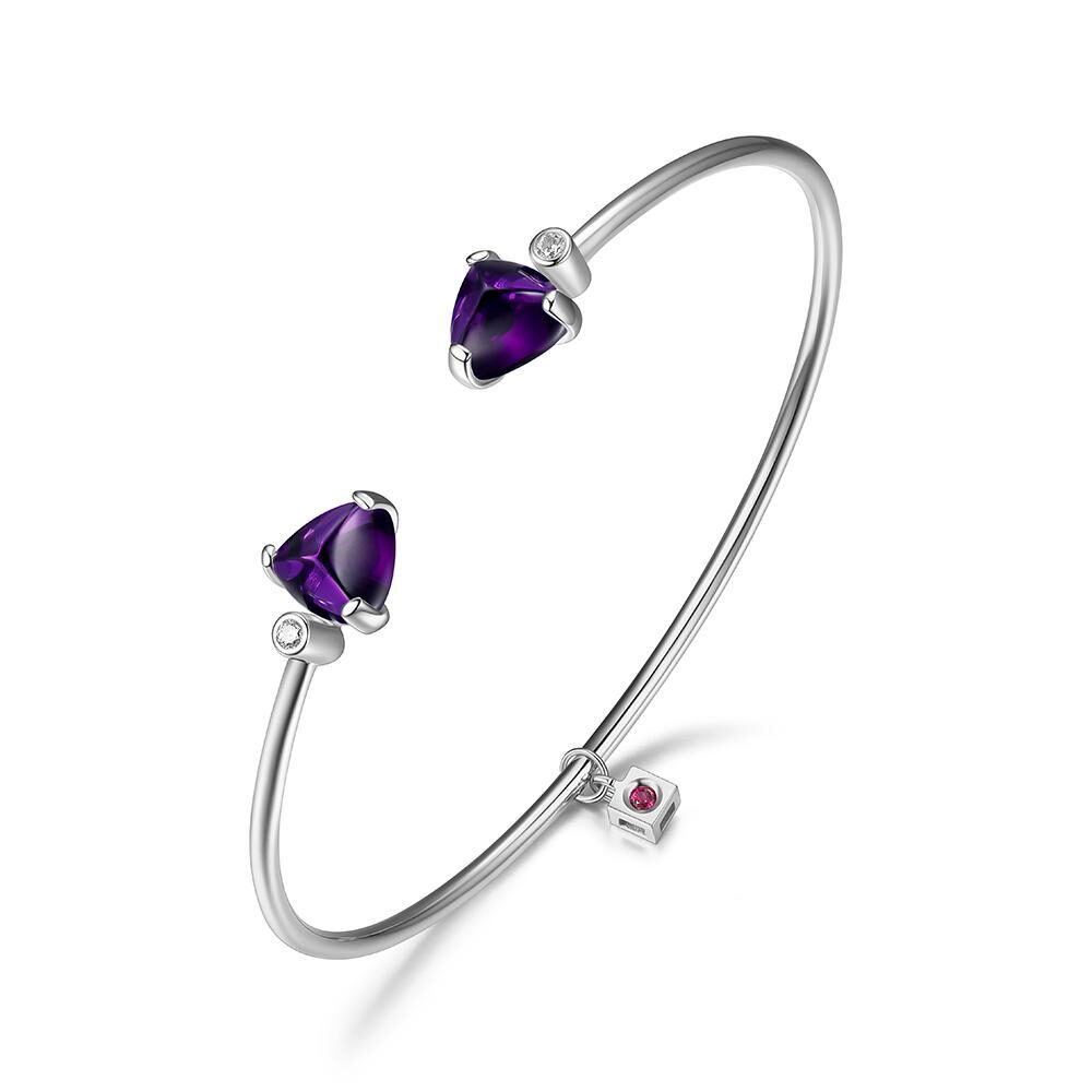 Elegant silver bangle with purple heart-shaped stones and a small charm.