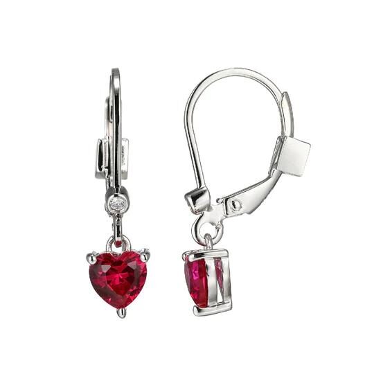 Elegant silver earrings with heart-shaped red gemstones.