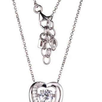 Silver necklace with a heart pendant and a sparkling stone.