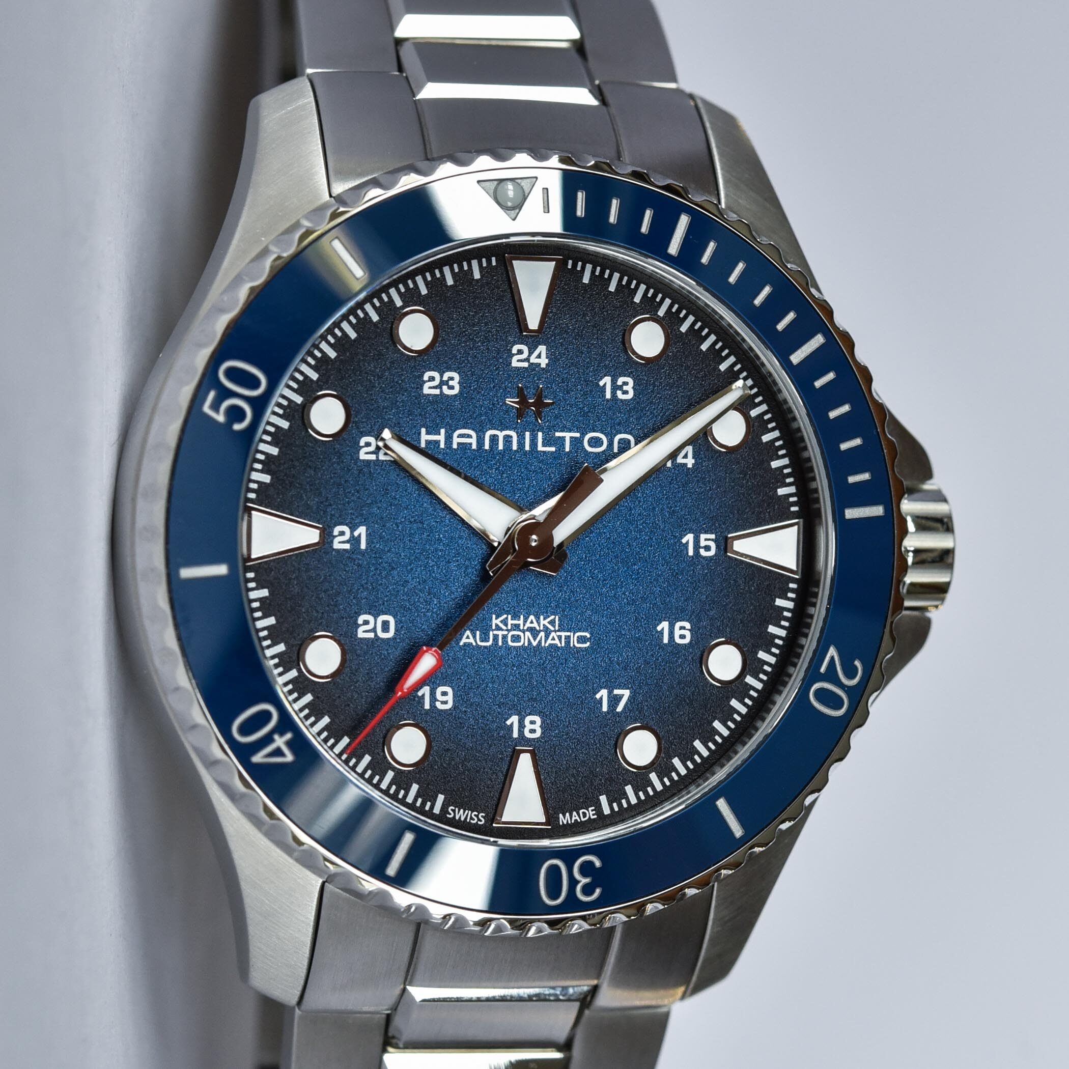 Hamilton dive watch with blue bezel and stainless steel bracelet.