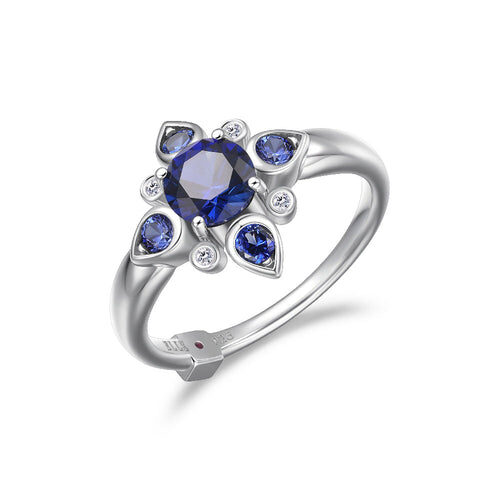 Elegant silver ring with blue gemstones in floral design.