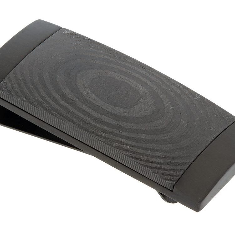 Black ergonomic footrest with a textured surface and curved design.