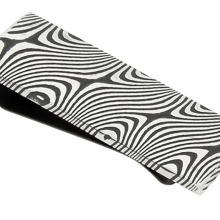 Close-up of a patterned black and white fabric with swirling lines.
