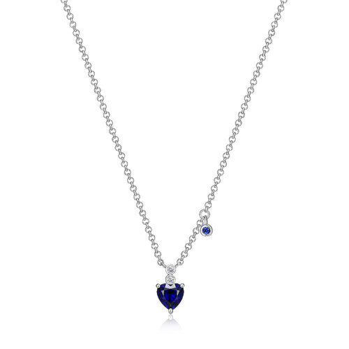 Elegant silver necklace with a heart-shaped blue pendant.