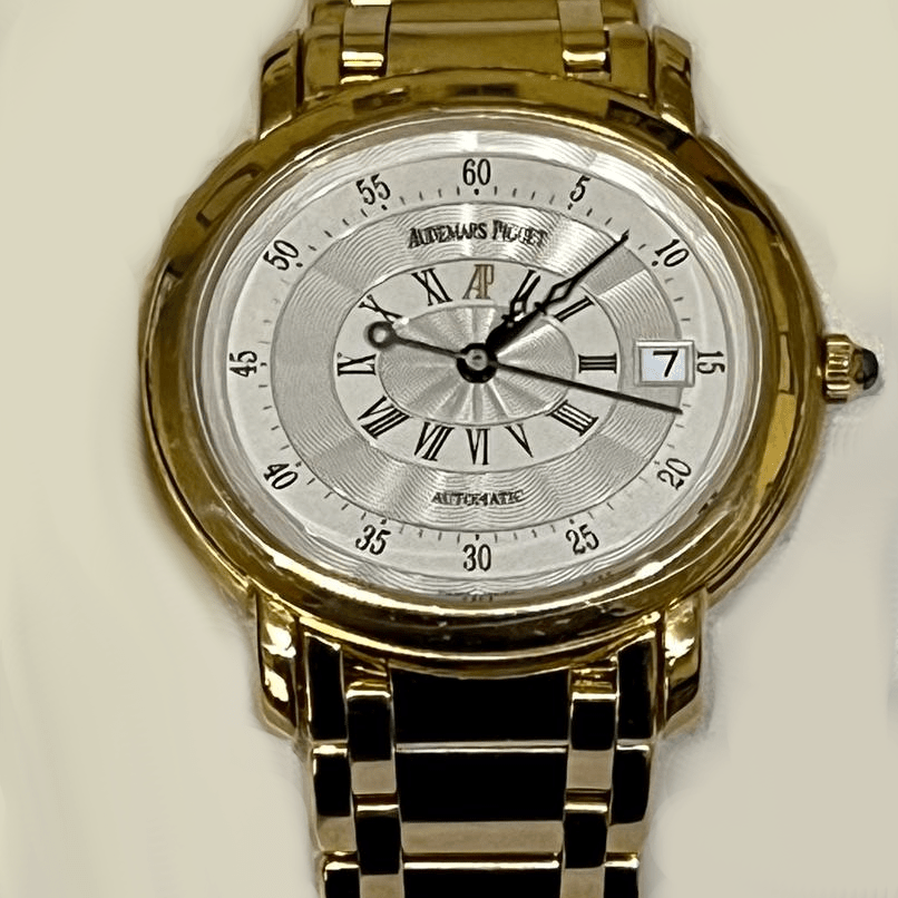 Gold wristwatch with a detailed silver dial and black leather strap.