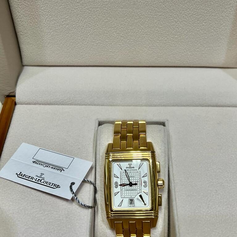 Elegant gold wristwatch with rectangular face and white dial.