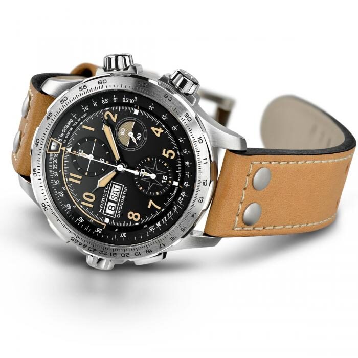 A stylish wristwatch with a tan leather strap and black dial with multiple functions.